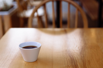 Cup of coffee on a wooden table.
