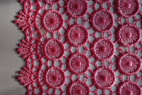 Pink crochet lace edge on neutral background