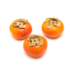 Three Fuyu persimmon isolated