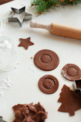 Process of baking homemade cookies or gingerbread. Round cookies made from raw dough, cut using a glass and decorated with the imprint of the bottom of the glass lies on the table. Selective focus