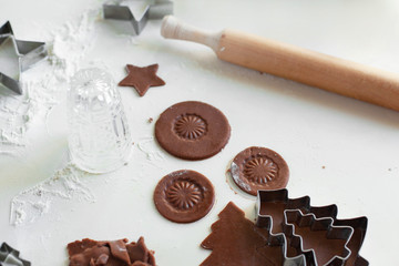 Process of baking homemade cookies or gingerbread. Round cookies made from raw dough, cut using a glass and decorated with the imprint of the bottom of the glass lies on the table. Selective focus