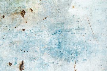 Old rusted metallic wall with blue peeling paint