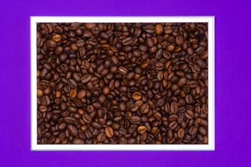 Roasted coffee beans in a silver frame on a purple background.