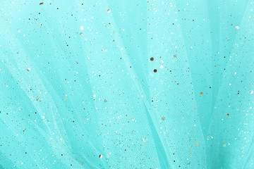 Feminine turquoise fabric background with golden glitter