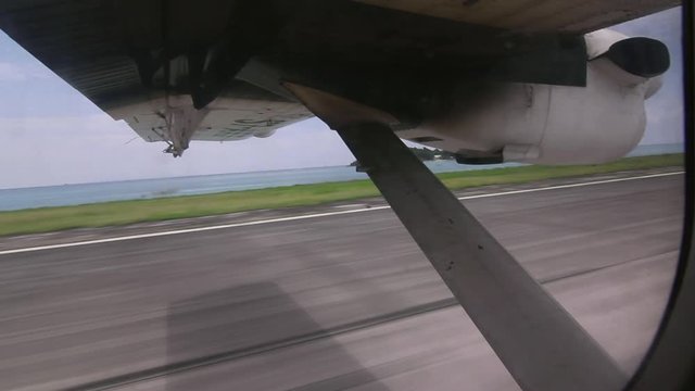 Small airplane take-off from ocean side runway in the Seychelles
