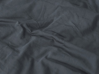 Chemical free textile concept. Folds on gray fabric background. Linens