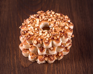 Round cookies with nuts on a wooden background