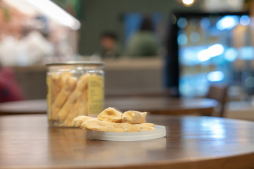 Almond nut meringue on dark wood table in coffee shop.
