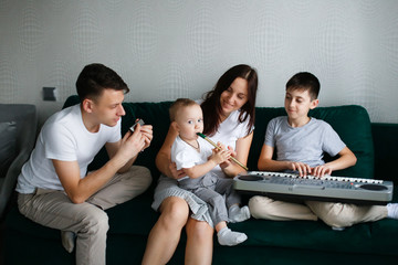 Caucasian family plays musical instruments