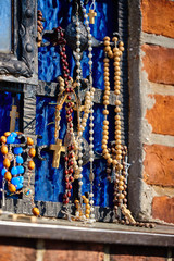 Colorful holy Marian rosaries hung at the place of the apparition in the sanctuary of the Mother of God in Gietrzwałd in Poland