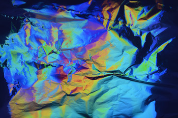 Fototapeta na wymiar Holographic iridescent crumpled foil texture background