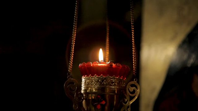 candle in a candlestick on a chain