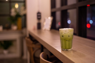 iced green tea with milk put on wooden table