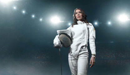 Female fencer on professional sports arena.