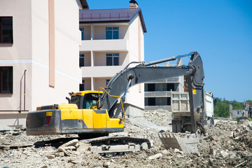 A large construction excavator of yellow color