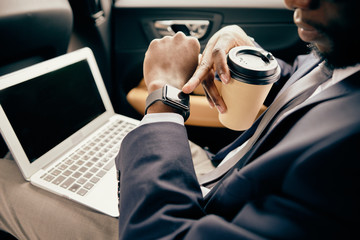 Close up of a man looking at watches in car.