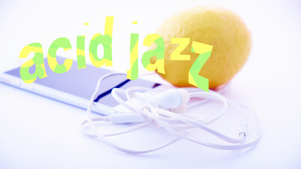 a white portable player and white headphones lie on a white table against a bright yellow lemon -...