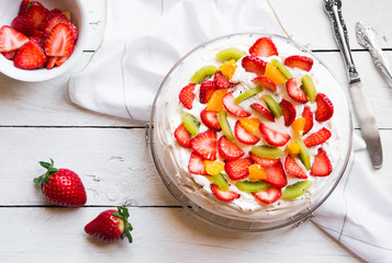 Delicious Pavlova cake with meringue and fresh strawberries
