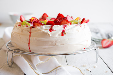 Delicious Pavlova cake with meringue and fresh strawberries