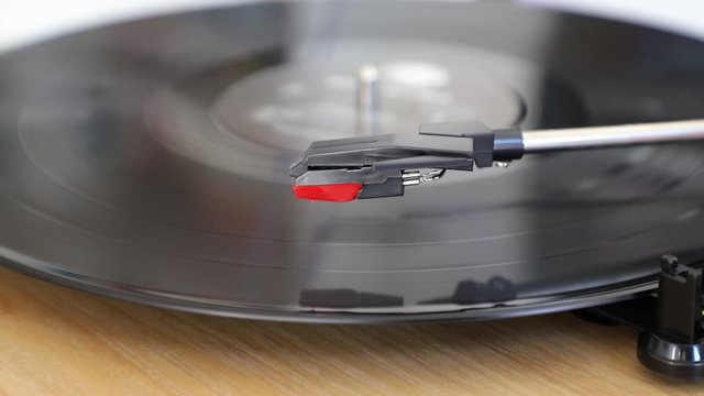 Disc turning on a turntable while the stylus lowers on it