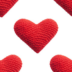 Seamless pattern with red knitted heart isolated on white background. Geometric pattern as symbol of love and Valentine's day greetings. Printable seamless repeat pattern background with heart.
