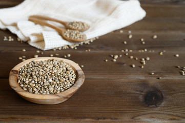 hemp seeds on a wooden background as a healthy food concept