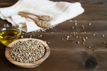 Fototapeta na wymiar hemp seeds on a wooden background as a healthy food concept