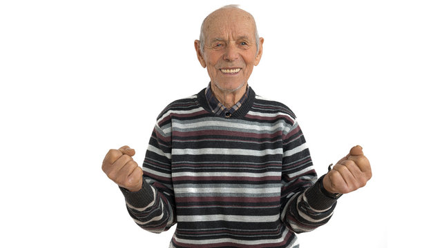 Waist Up Portrait Of The Old Man In Casual Clothes, Senior Is Very Happy And Excited Doing Winner Gesture With Arms Raise, Looking At The Camera, Isolated Over White Background. Celebration Concept