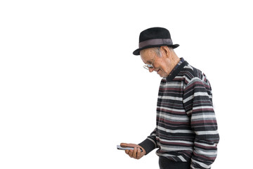Handsome old man in casual clothes, black hat and sunglasses, senior looking attention at his smartphone to reading news, isolated over white background, copyspace