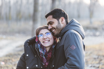 Happy young joyful couple having fun moments and laughing together in autumn season