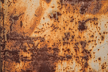 Heavily corroded metal surface with remnants of faded light  paint. Abstract background, texture.