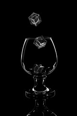 glass for scotch whiskey with ice on black background