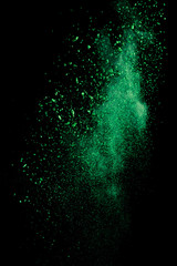green colorful holi paint explosion on black background