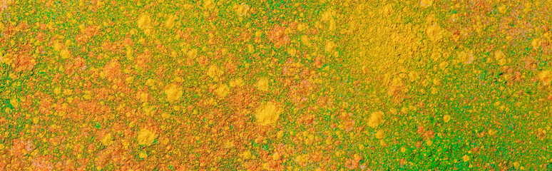 orange, yellow and green colorful holi paint explosion, panoramic shot