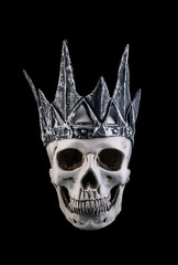 Human skull with crown isolated on black background