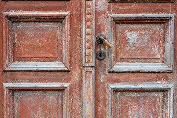 Fragment of a vintage door with peeling paint.