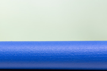 blue yoga mat texture on green background