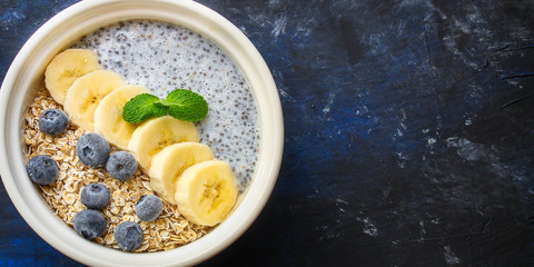 healthy food smoothie bowl, oatmeal, chia seeds and berries (breakfast dish or healthy snack) menu concept. background. top view. copy space