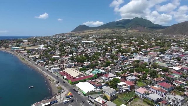 Saint Kitts and Nevis, Caribbean - The Stunning Scenery Of Different Buildings and Trees With Blue Calm Ocean - Aerial Shot