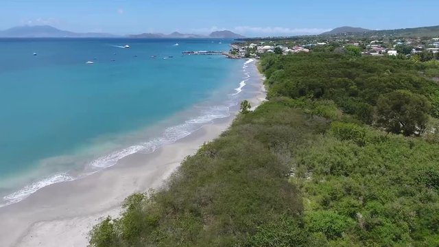 The Stunning Scenery Of Bright Blue Ocean and Glorious Trees On A Sunny Day In Saint Kitts and Nevis, Caribbean - Perfect for Summer Vacation - Aerial Shot