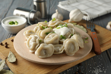 Composition with tasty dumplings on wooden background, close up