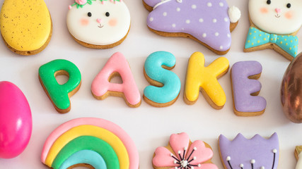 Obraz na płótnie Canvas Happy Easter. Multicolored pastel easter cookies on a white background.