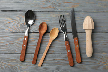 Cutlery on rustic wooden background, top view