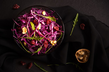 Red cabbage salad with nuts and arugola