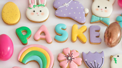 Happy Easter. Multicolored pastel easter cookies on a white background.
