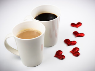Two cup of coffee with red glitter hearts on white background , Valentine's concept.