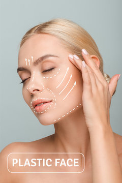 young beautiful woman with closed eyes touching face with plastic surgery marks isolated on grey