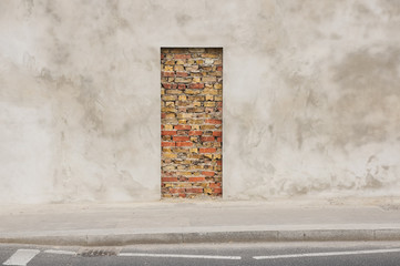 wall with doorway immured with bricks