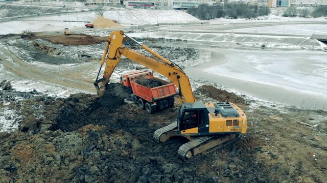 Quarry site with an excavator digging ground