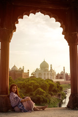 Asian woman posing over Taj Mahal, Agra, India